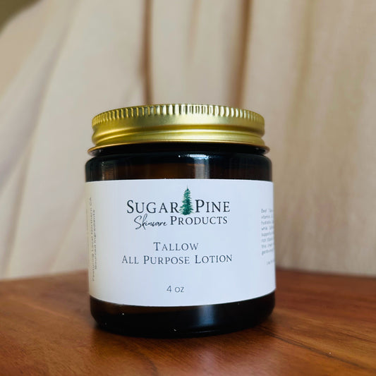 Small jar of all-purpose lotion with a gold lid on a wooden surface. sugar pine products all purpose tallow lotion