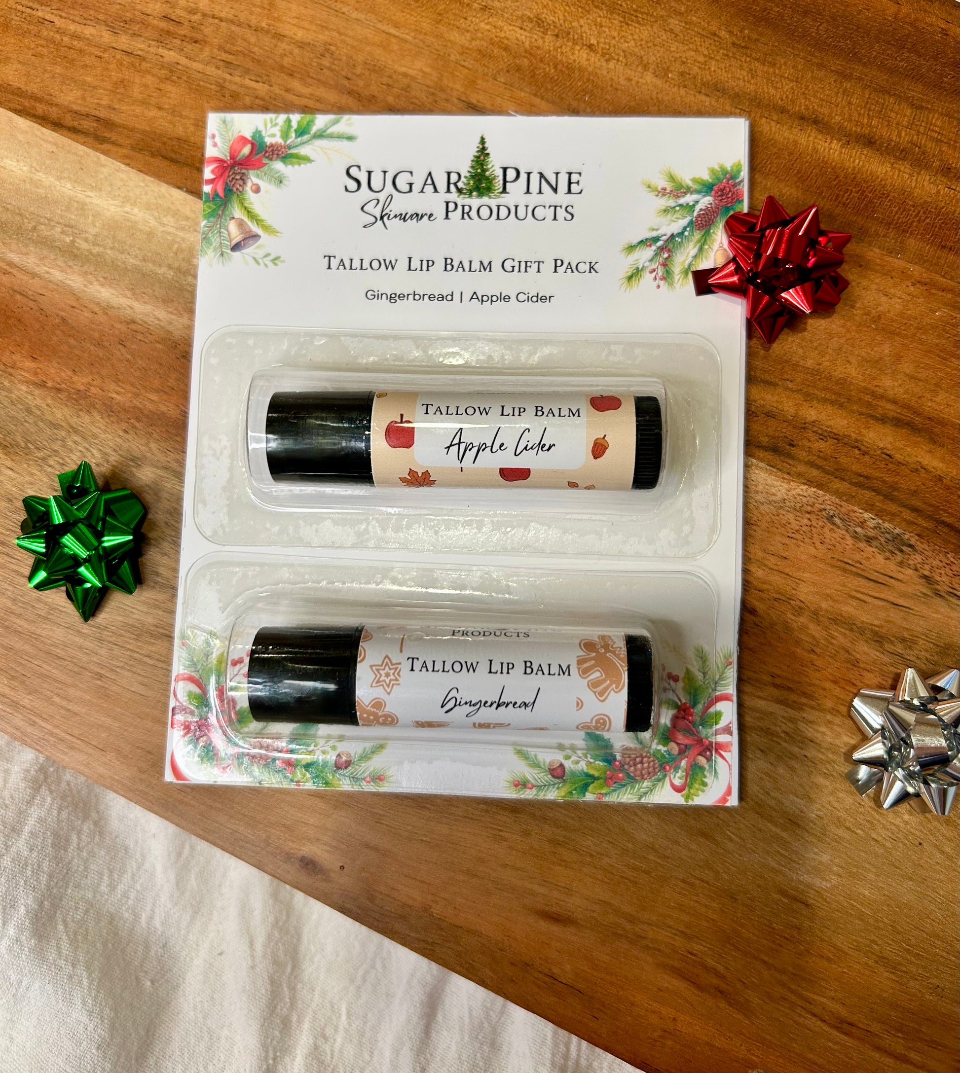 Sugar Pine Skincare Tallow Lip Balm gift pack on a wooden surface with decorative bows.