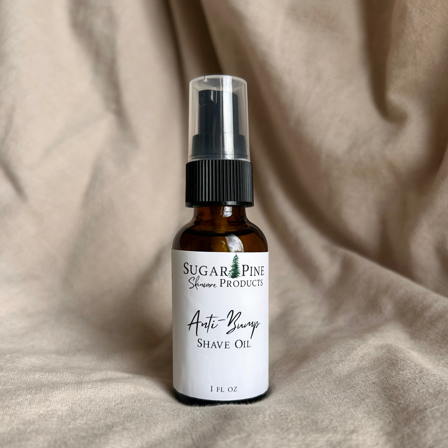 Bottle of Sugar Pine Shave Oil on a beige fabric background