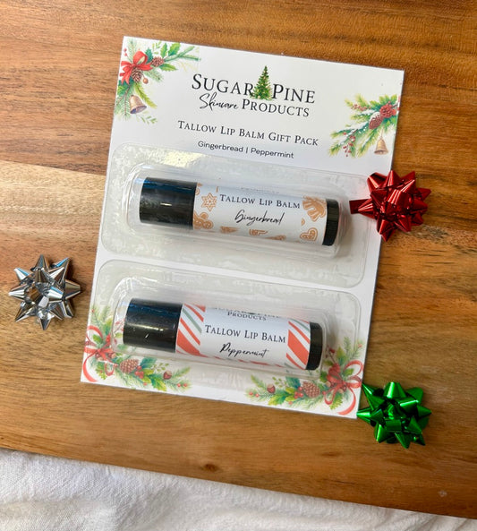Sugar Pine Products tallow lip balm gift pack on a wooden surface with decorative bows.