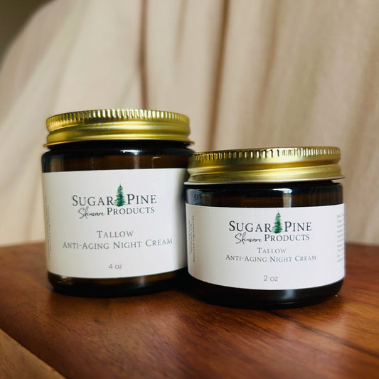 Two jars of Sugar Pine Skincare tallow anti aging night cream on a wooden surface