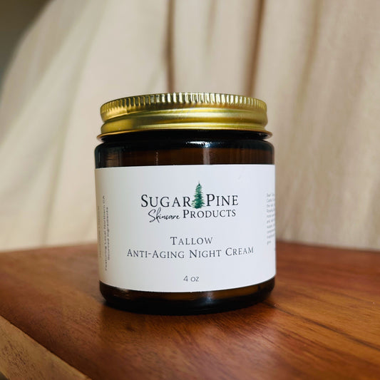 Small jar of cream with a gold lid on a wooden surface Sugar Pine Skincare tallow anti aging night cream 