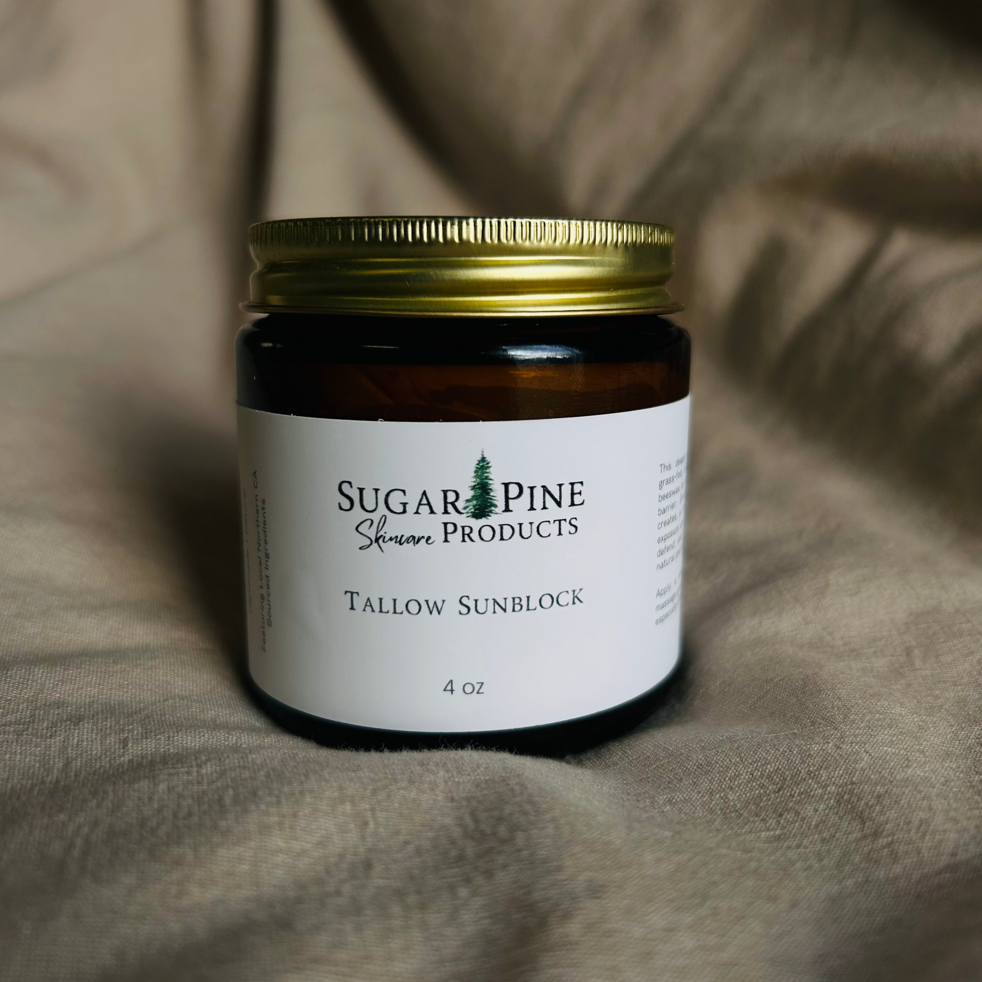 glass jar of tallow sunblock from sugar pine products